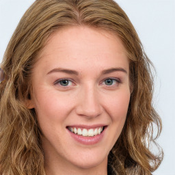 Joyful white young-adult female with long  brown hair and green eyes