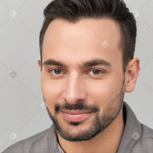 Joyful white young-adult male with short  brown hair and brown eyes