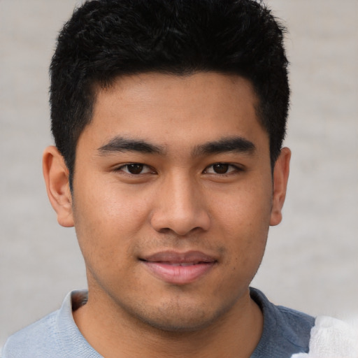 Joyful asian young-adult male with short  black hair and brown eyes