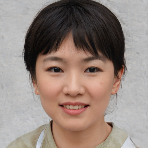 Joyful asian child female with medium  brown hair and brown eyes