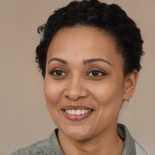 Joyful latino adult female with short  brown hair and brown eyes