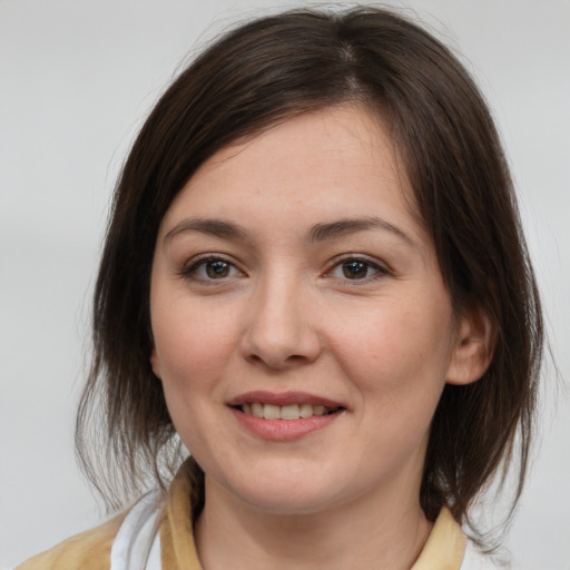 Joyful white young-adult female with medium  brown hair and brown eyes