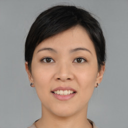 Joyful asian young-adult female with medium  black hair and brown eyes