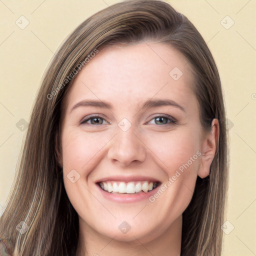 Joyful white young-adult female with long  brown hair and grey eyes