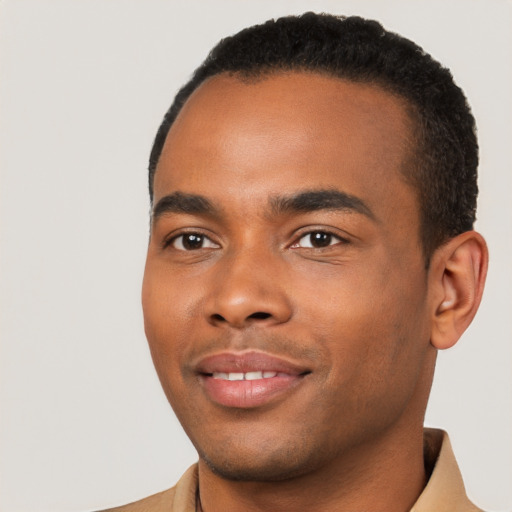 Joyful black young-adult male with short  black hair and brown eyes