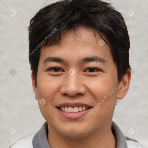 Joyful asian young-adult male with short  brown hair and brown eyes