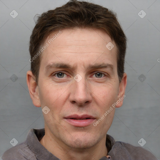 Joyful white adult male with short  brown hair and grey eyes