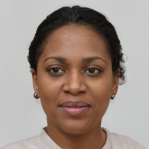 Joyful black young-adult female with short  brown hair and brown eyes