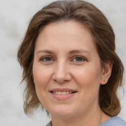 Joyful white adult female with medium  brown hair and brown eyes