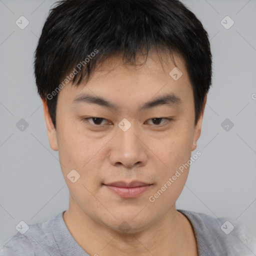 Joyful asian young-adult male with short  brown hair and brown eyes