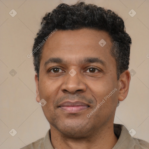 Joyful latino adult male with short  black hair and brown eyes