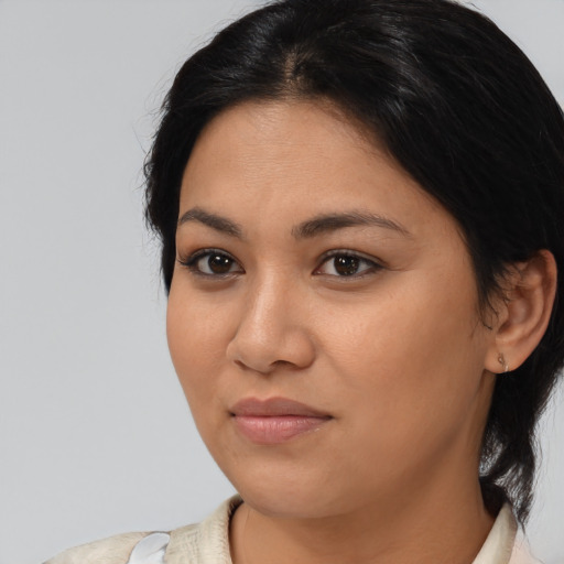 Joyful latino young-adult female with medium  black hair and brown eyes