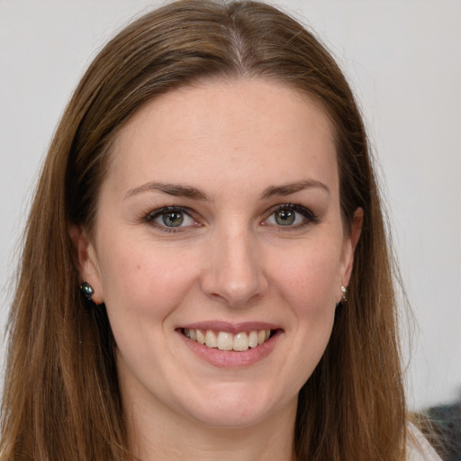 Joyful white young-adult female with long  brown hair and grey eyes