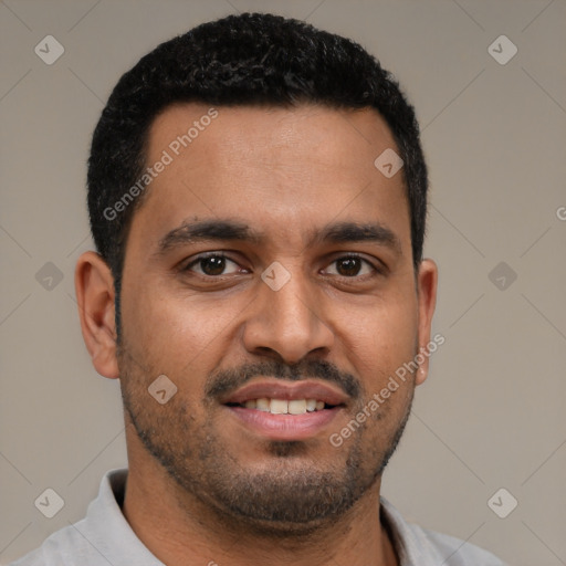 Joyful black young-adult male with short  black hair and brown eyes