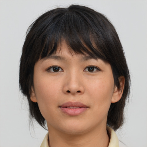 Joyful asian young-adult female with medium  brown hair and brown eyes