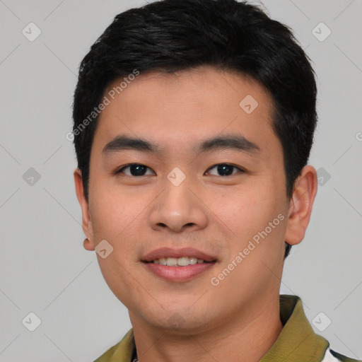 Joyful asian young-adult male with short  black hair and brown eyes