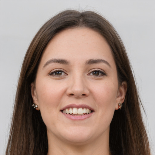 Joyful white young-adult female with long  brown hair and grey eyes