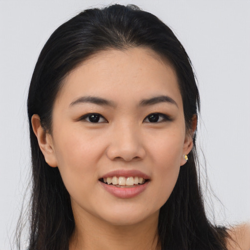 Joyful asian young-adult female with long  black hair and brown eyes