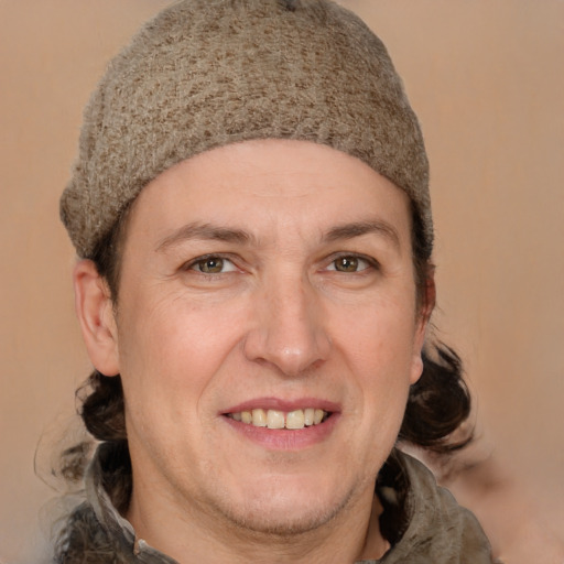 Joyful white adult male with medium  brown hair and grey eyes