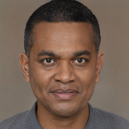 Joyful latino adult male with short  black hair and brown eyes