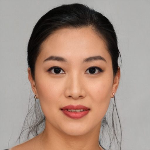 Joyful asian young-adult female with medium  brown hair and brown eyes
