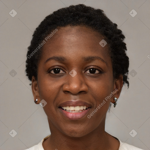 Joyful black young-adult female with short  black hair and brown eyes