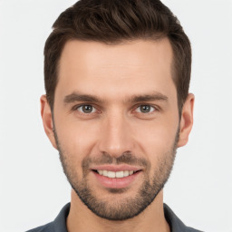 Joyful white young-adult male with short  brown hair and brown eyes