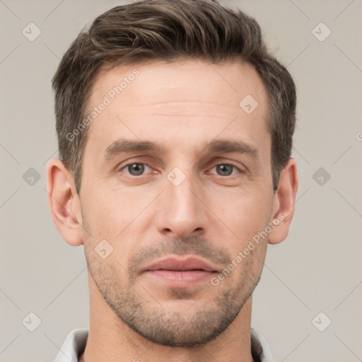 Joyful white adult male with short  brown hair and brown eyes