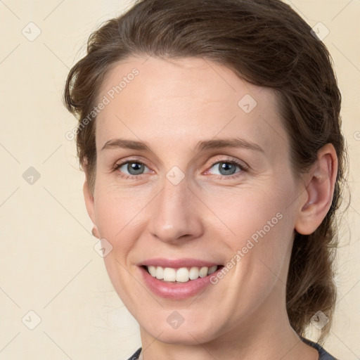 Joyful white young-adult female with medium  brown hair and grey eyes