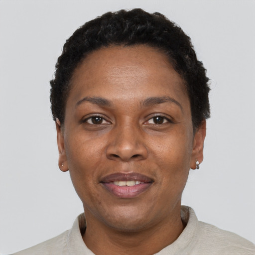 Joyful black adult female with short  black hair and brown eyes