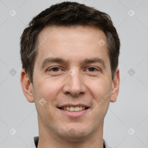 Joyful white adult male with short  brown hair and brown eyes