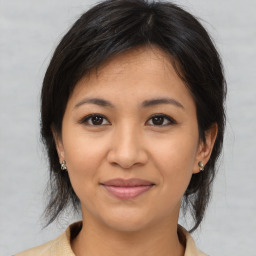 Joyful asian young-adult female with medium  brown hair and brown eyes