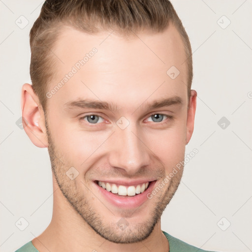 Joyful white young-adult male with short  brown hair and grey eyes