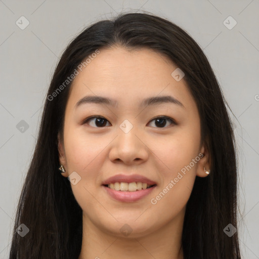 Joyful asian young-adult female with long  brown hair and brown eyes