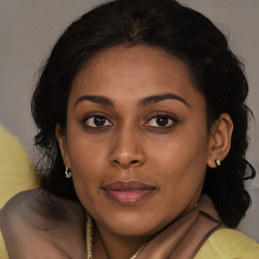 Joyful black young-adult female with medium  brown hair and brown eyes