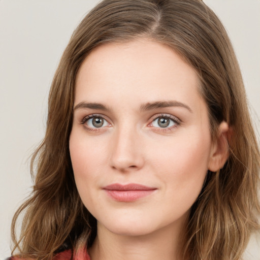 Joyful white young-adult female with long  brown hair and green eyes