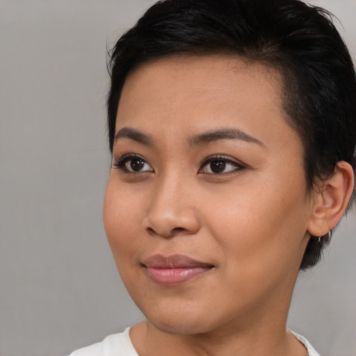 Joyful asian young-adult female with short  brown hair and brown eyes