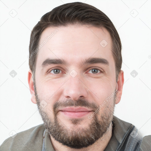 Joyful white young-adult male with short  brown hair and grey eyes