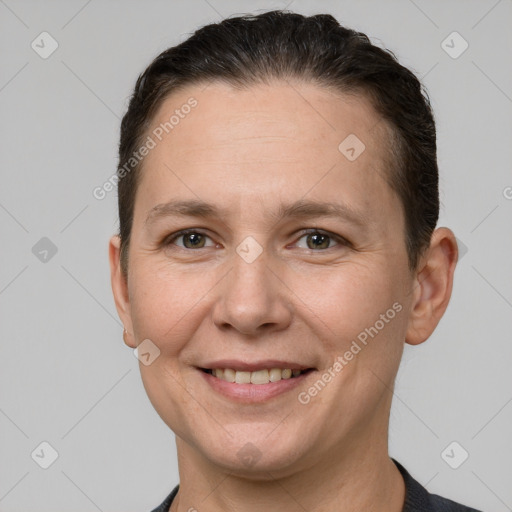 Joyful white adult female with short  brown hair and grey eyes