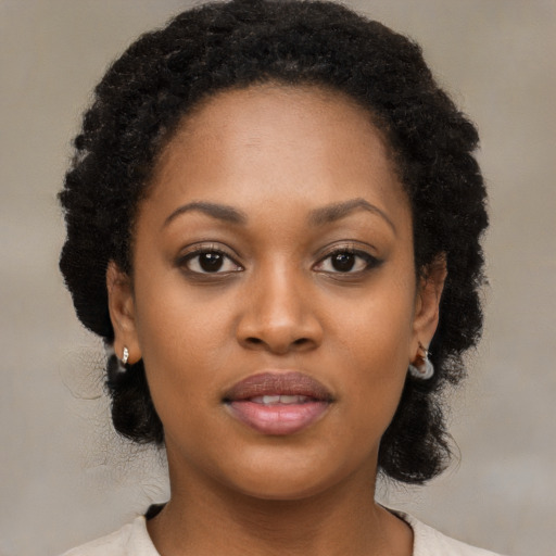Joyful black young-adult female with short  black hair and brown eyes