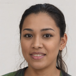 Joyful latino young-adult female with long  brown hair and brown eyes