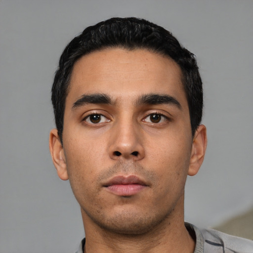 Neutral latino young-adult male with short  black hair and brown eyes