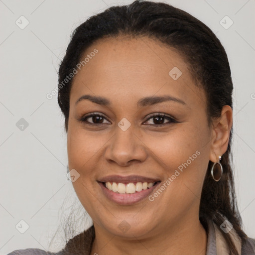 Joyful latino young-adult female with long  brown hair and brown eyes