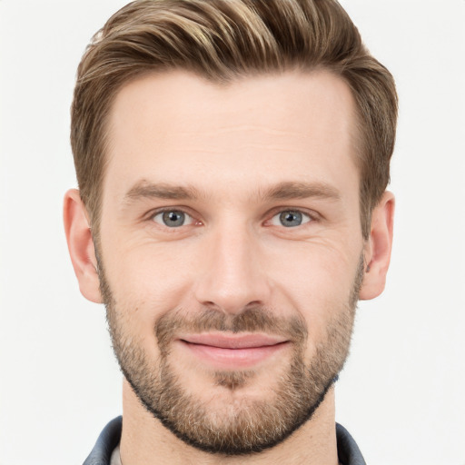 Joyful white young-adult male with short  brown hair and grey eyes