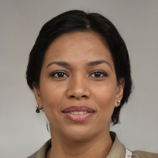 Joyful black young-adult female with medium  brown hair and brown eyes