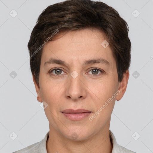 Joyful white adult female with short  brown hair and grey eyes