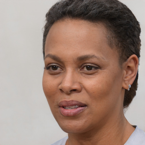 Joyful black adult female with short  brown hair and brown eyes