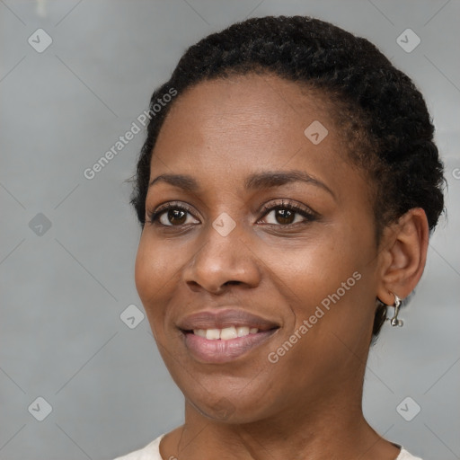 Joyful black young-adult female with short  black hair and brown eyes