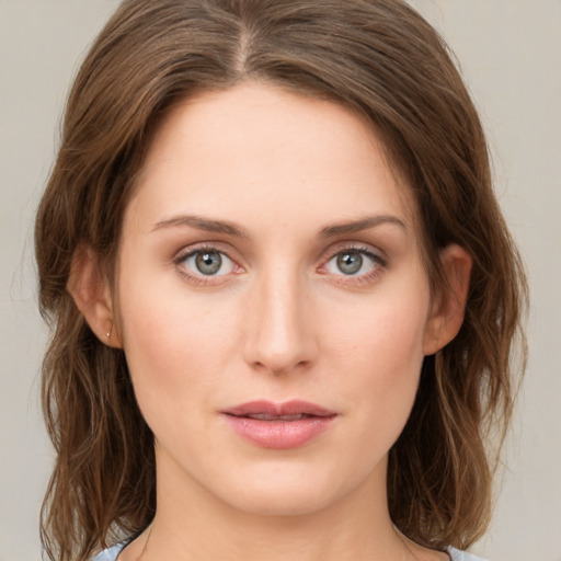 Joyful white young-adult female with medium  brown hair and green eyes