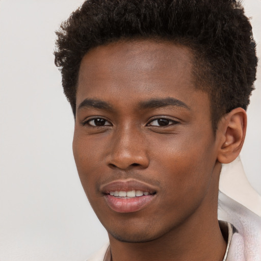 Joyful black young-adult male with short  brown hair and brown eyes